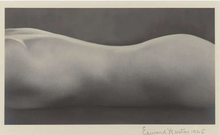 Edward Weston’s Nude, 1925: a closely framed reclining adult torso, its curved outline set against a dark background